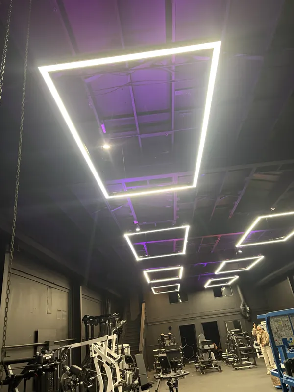 Decorative LED fixture installed on a high commercial ceiling in Belmont